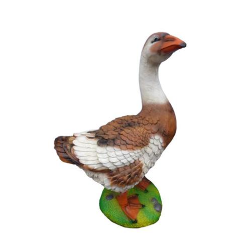 Decorative sculpture designed as a light brown white colored standing duck on grass 50cm