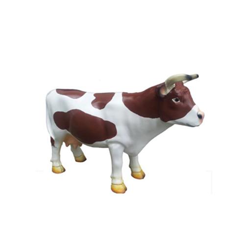 Cartoon deco figure of a gloss motley white brown colored standing cow 28cm