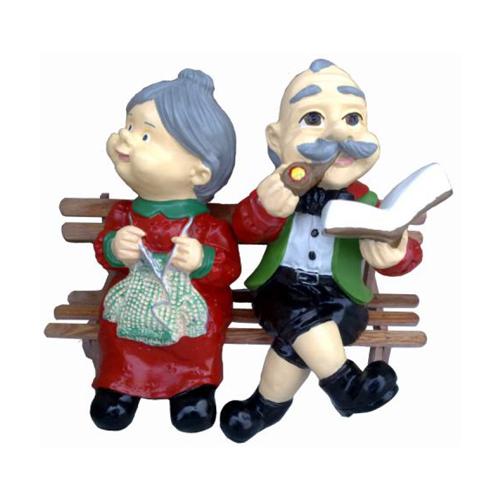 Decorative sculpture designed as colorful adults on a wooden bench 25cm