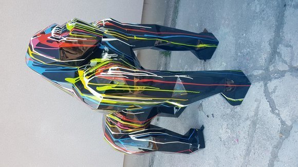 Abstract geometric decorative sculpture designed as black colored gorilla with colorful stripes