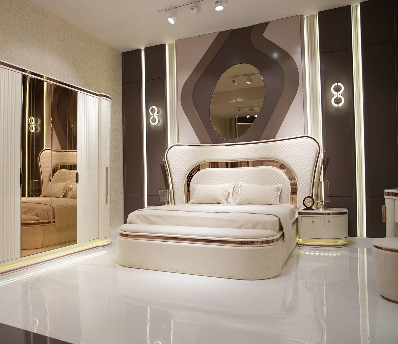 Elegant white wooden bedroom set with bed and nightstands.