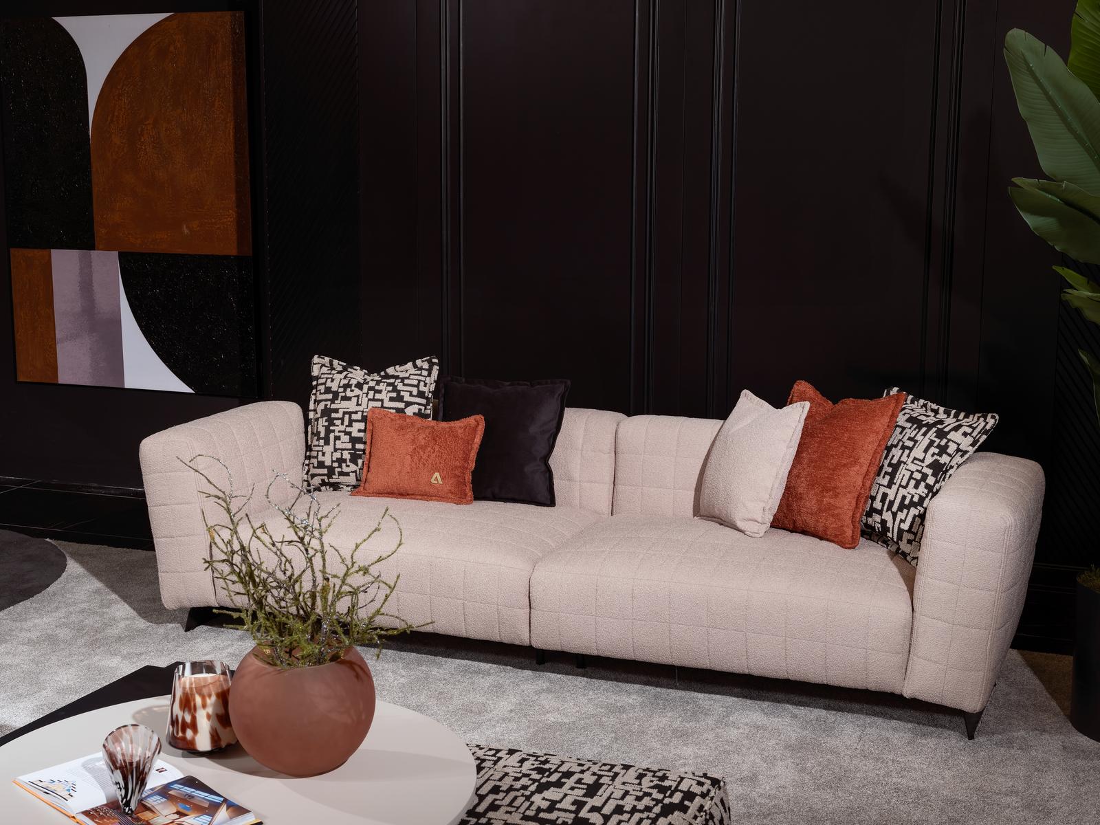 Elegant beige textile sofa with wooden frame for a modern living room.