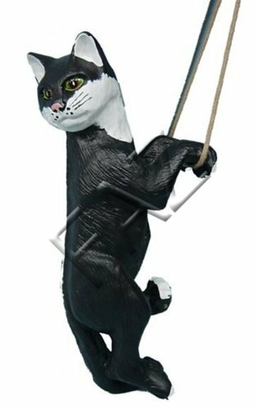 Decorative sculpture designed as a mobley white black colored cat on a rope 50cm height