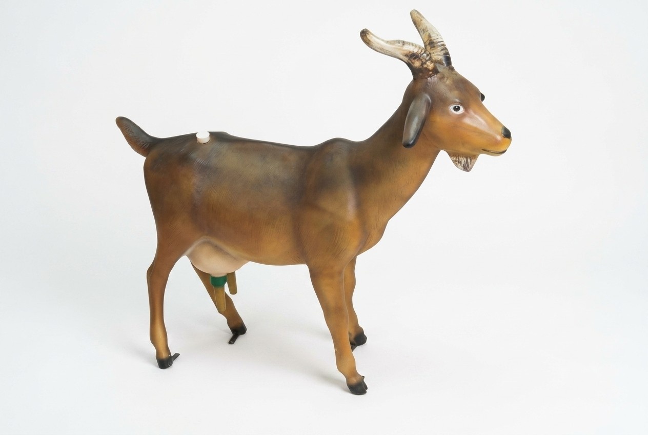 Garden decorative sculpture designed as motley brown colored goat with a cork 110x122x32cm
