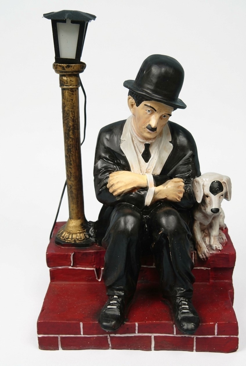 Decor light figure designed as a sad charlie chaplin with puppy sitting across a lamp