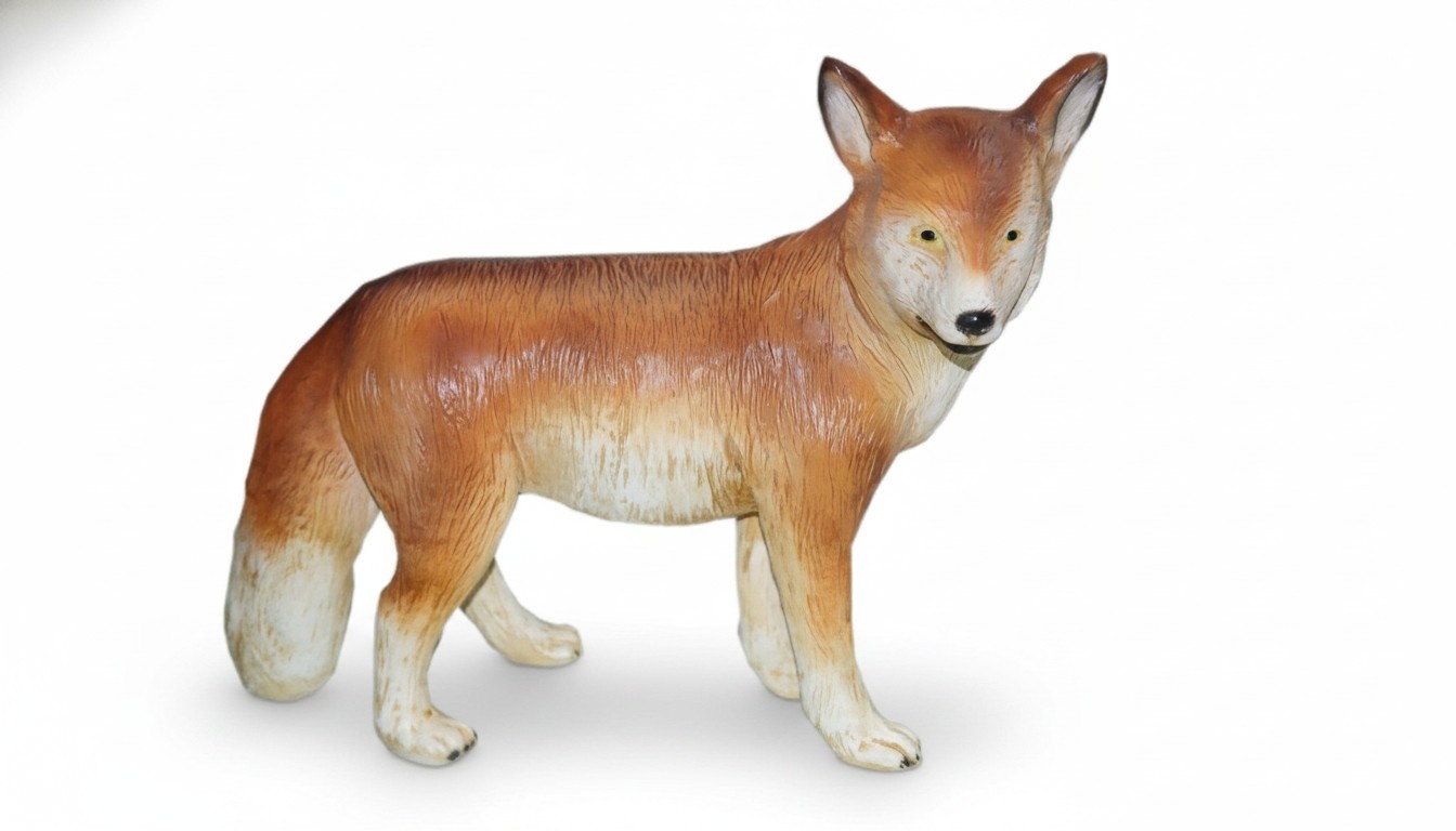 Decorative sculpture designed as motley orange white colored walking fox figure