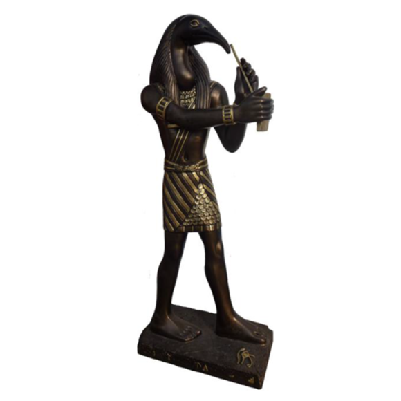 Ancient egyptian decorative sculpture of brown colored thoth deity with golden decorations