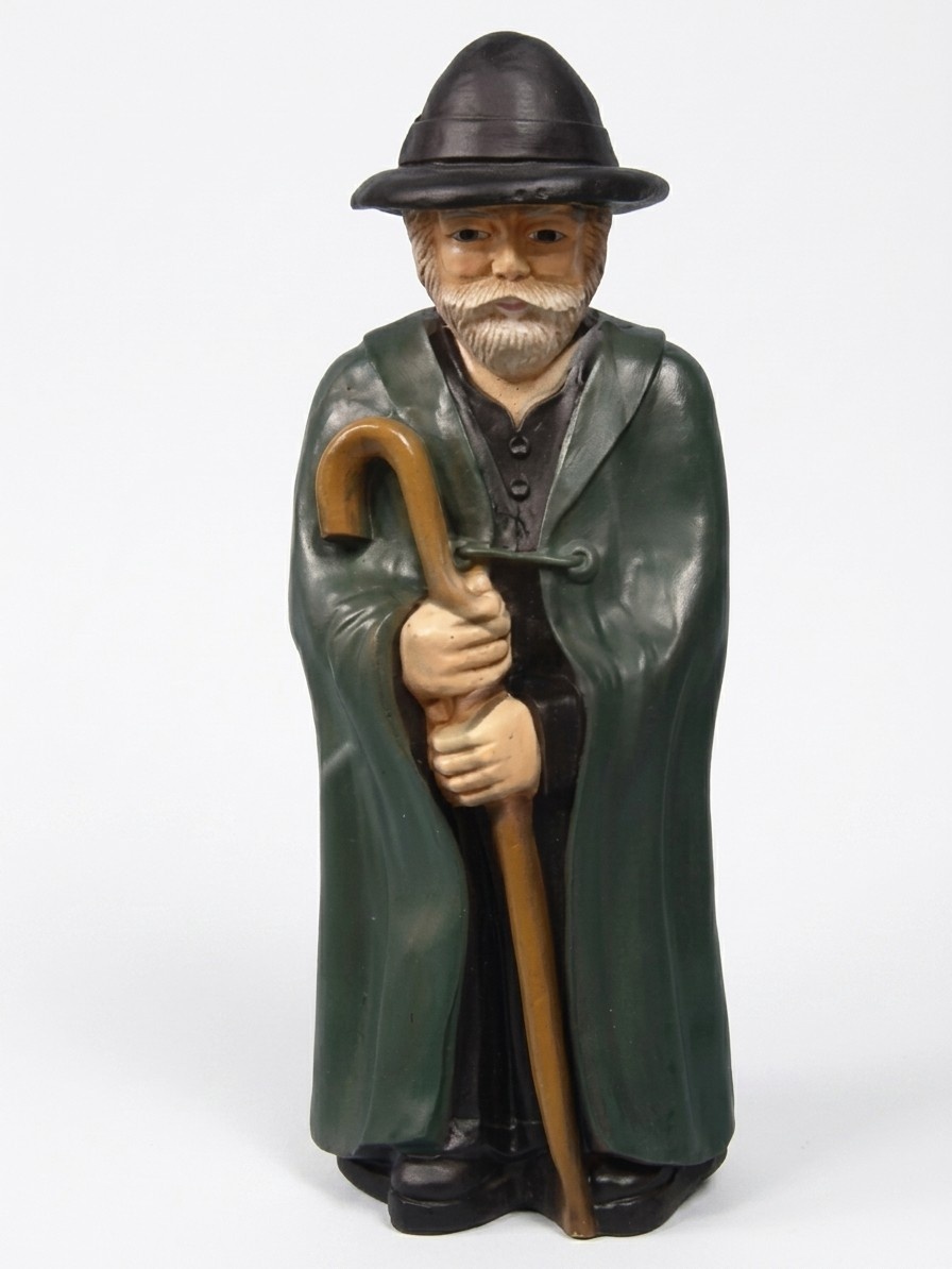 Decorative sculpture designed as shepherd in a black raincoat with a cane 95cm