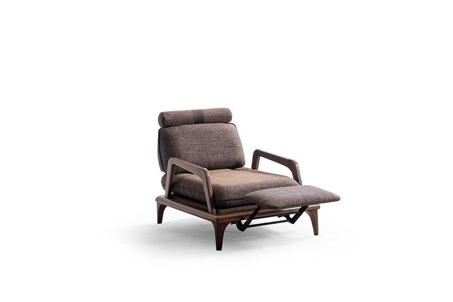Living room armchair with footrest function designed in brown textile.