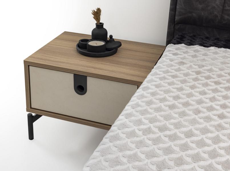 Modern bedside table in cream with one drawer and black handle details.