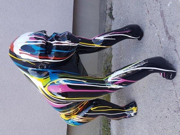 Modern style abstract decorative sculpture designed as full gloss black colored gorilla with colorful stripes 70cm height