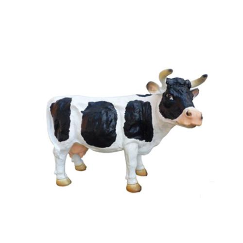Cartoon deco figure of a gloss motley white black colored standing cow 28cm