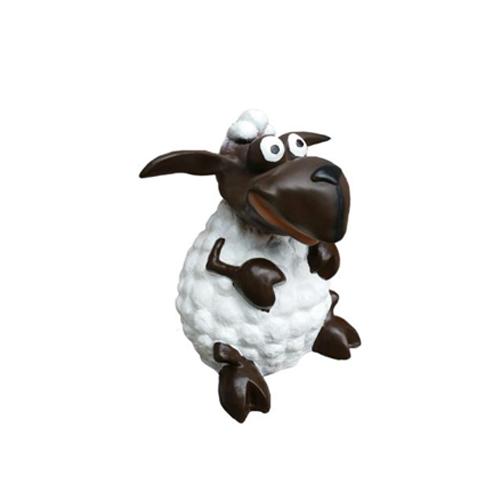 Cartoon deco figure of a motley brown white colored shaggy sitting lamb 29cm