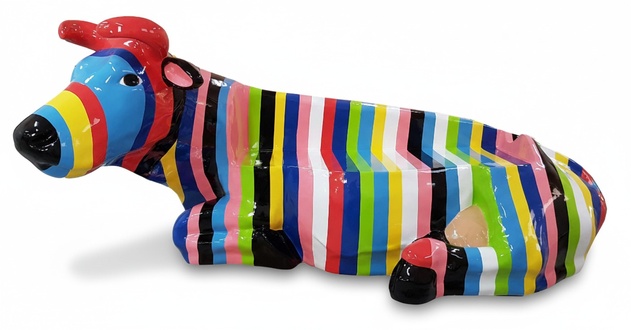 Abstract decorative sculpture of a lying cow with colorful stripes 200cm height