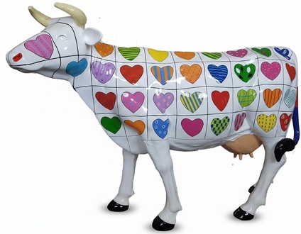 Abstract sculpture designed as white lying cow with hearts patterns 147 cm height
