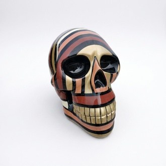 Abstract decorative sculpture designed as a gloss black skull in golden red stripes 66cm