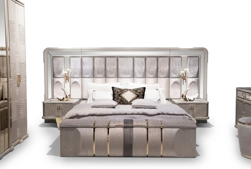 Bedroom set in gray wood with bed, nightstands, and bench.
