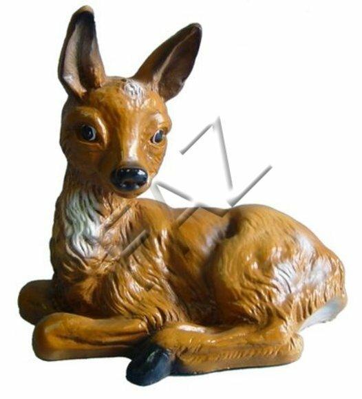 Decorative sculpture designed as motley light brown colored lying fawn without horns