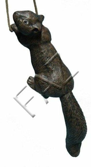 Decorative sculpture designed as dark grey colored motley hanging on a rope squirrel