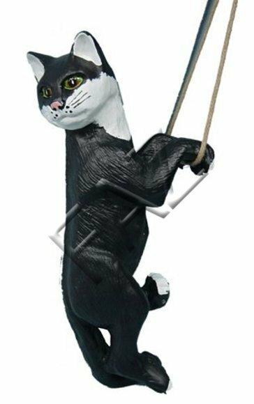 Decorative sculpture designed as a mobley white black colored cat on a rope 50cm height