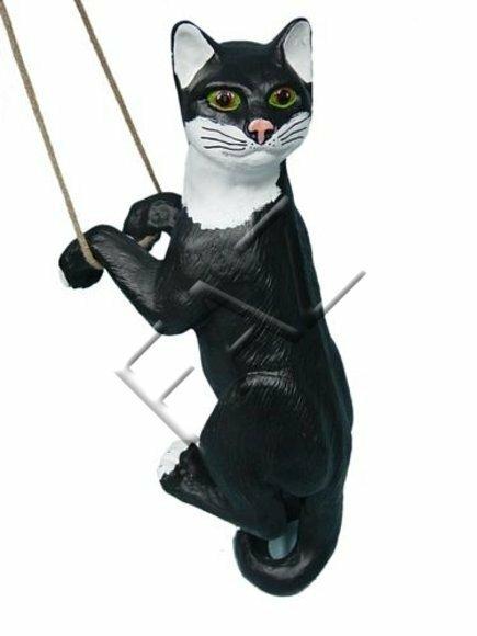 Decorative sculpture designed as a mobley black white colored cat on a rope 50cm height C206