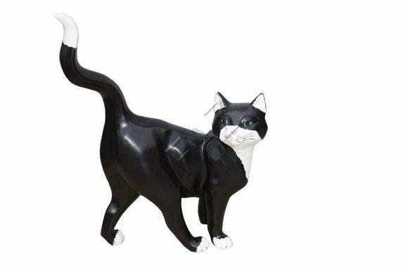 Decorative sculpture designed as motley black white colored walking cat 50 x 40 x 18 cm