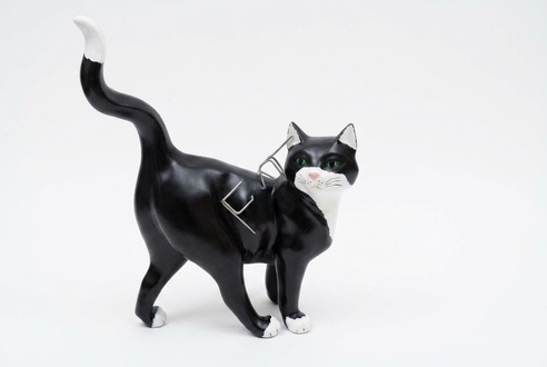 Decorative sculpture designed as motley black white colored walking cat 50 x 40 x 18 cm