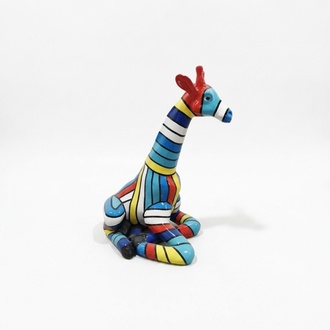 Decorative sculpture designed as a gloss sitting giraffe in light multi-colored stripes 80cm