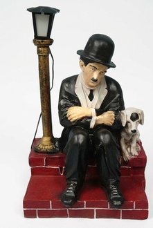 Decor light figure designed as a sad charlie chaplin with puppy sitting across a lamp