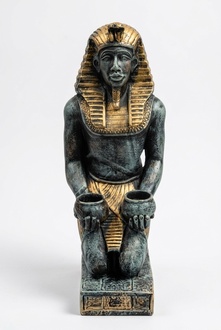 Grey golden colored deco figure of an ancient egyptian sitting servant holding two cups