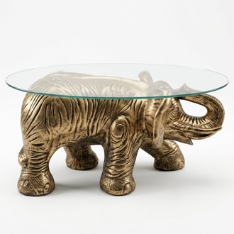 Oval glass coffee table with a decorative golden elephant sculpture 40cm