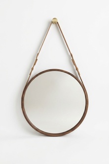 Framed wall mirror with a luxurious brown frame made of natural walnut wood.