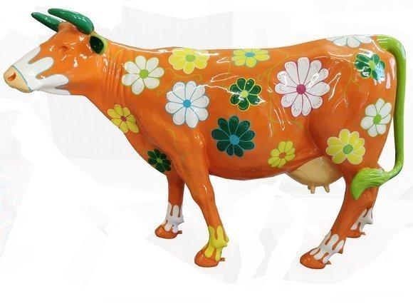 Abstract sculpture of a colorful orange cow figure with flowers patterns XXL 147 cm length