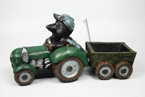 Decorative sculpture designed as black colored mole miner on a tractor with a carriage