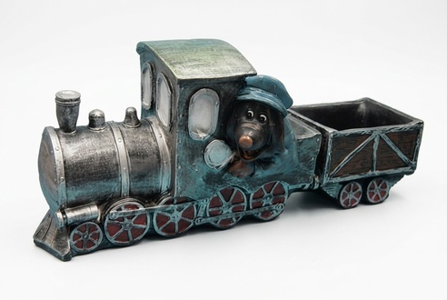 Decorative sculpture designed as black colored mole miner on a locomotive with a carriage