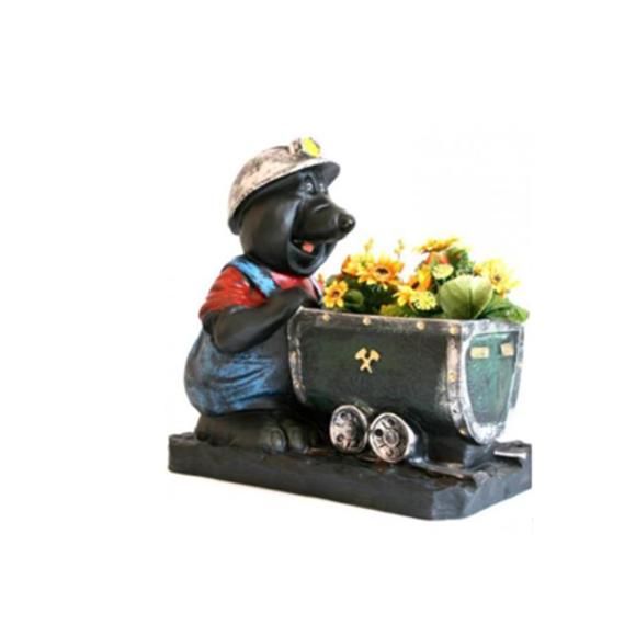Decorative sculpture designed as a black mole miner with a trolley full of sunflowers