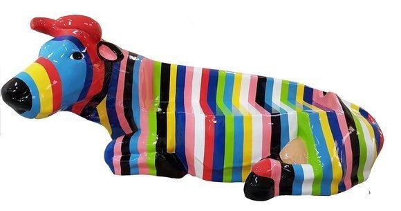 Abstract decorative sculpture of a lying cow with colorful stripes 200cm height