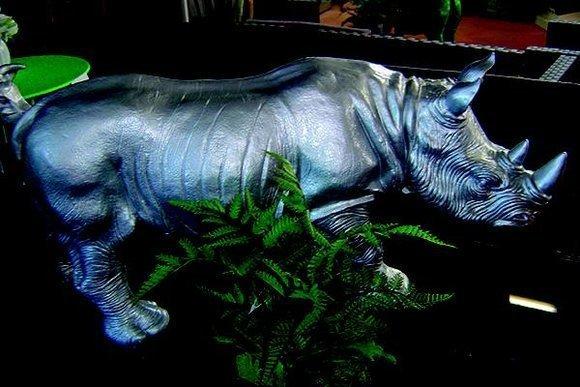 Decorative sculpture designed as full silver colored standing rhino 38x60cm